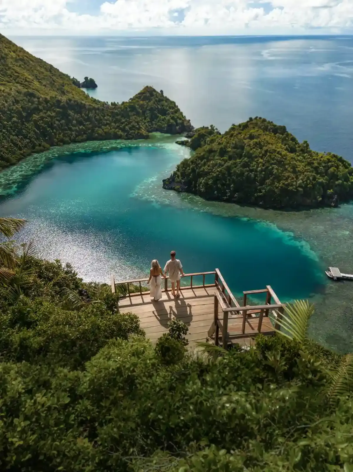 Travellers on the Piaynemo viewpoint deck above Raja Ampat