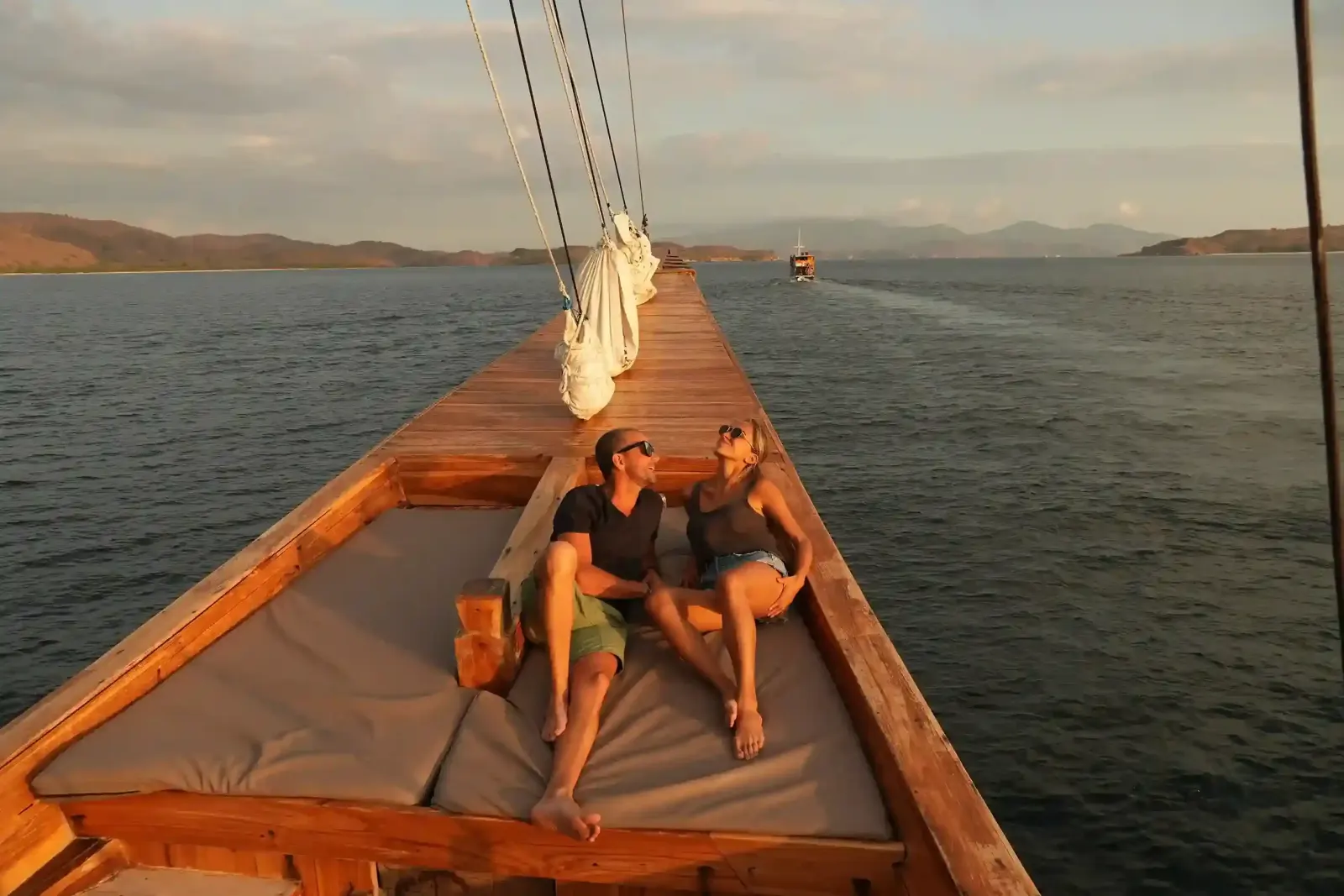 Guests relaxing on the bow of a phinisi boat