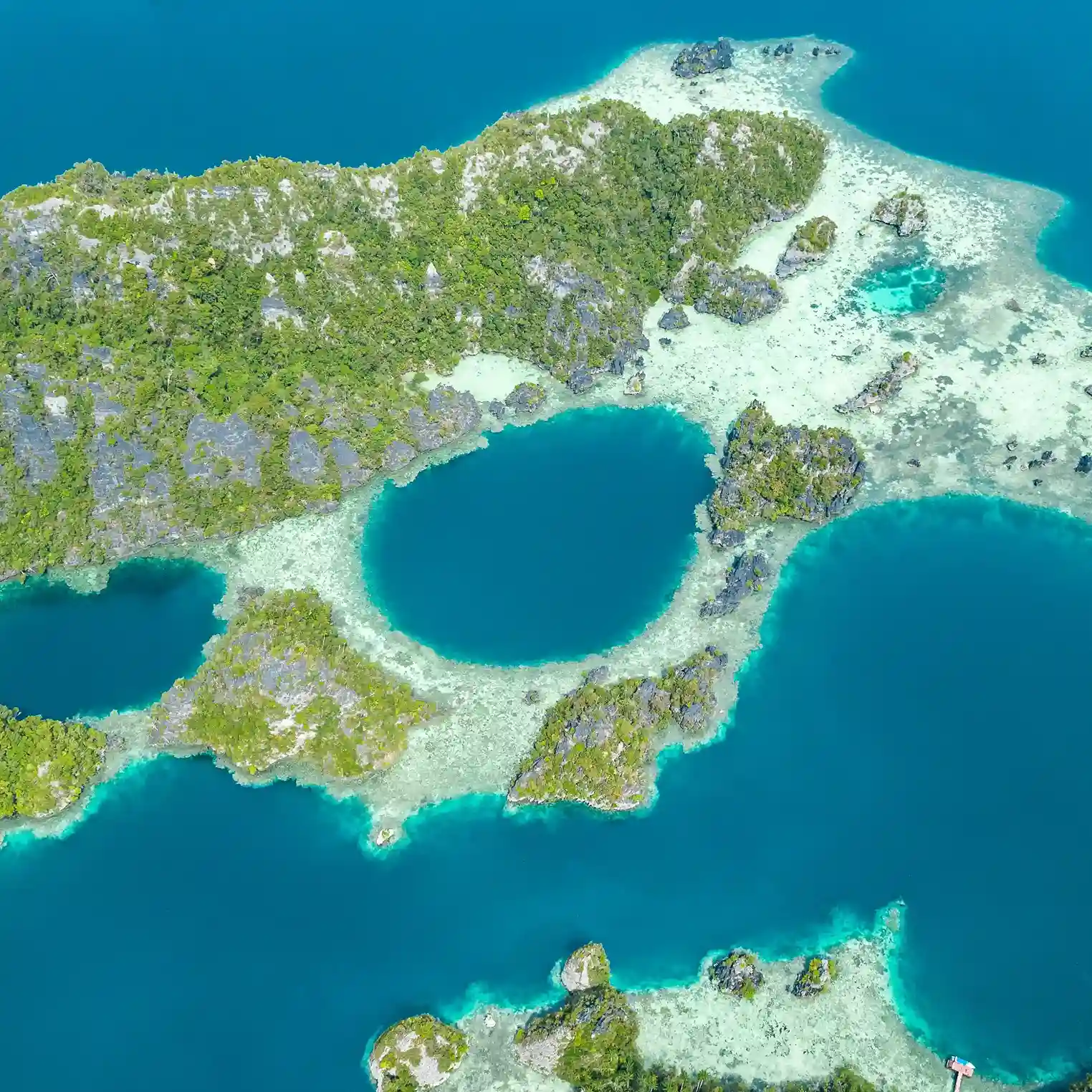 Aerial view of a lagoon between limestone karst islands